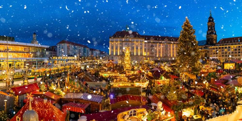top view of a crowded christmas market with a building on the background - best christmas markets in the world