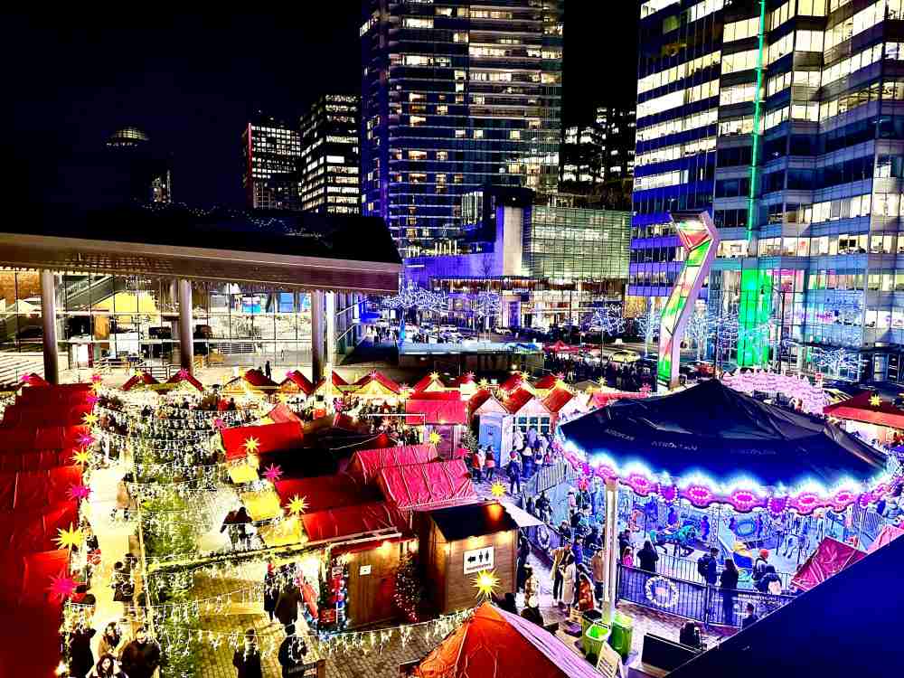 Top view of a christmas market surrounded by tall building