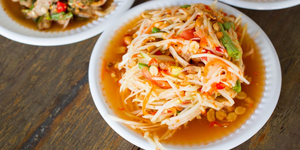 shredded green papaya with red sauce and other veggies