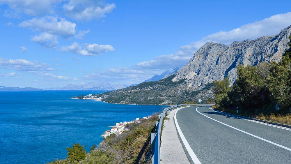 empty road with ocean view- Best road trips in Europe