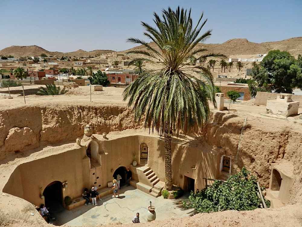 underground with doors inside a cave like structure and palmtree
