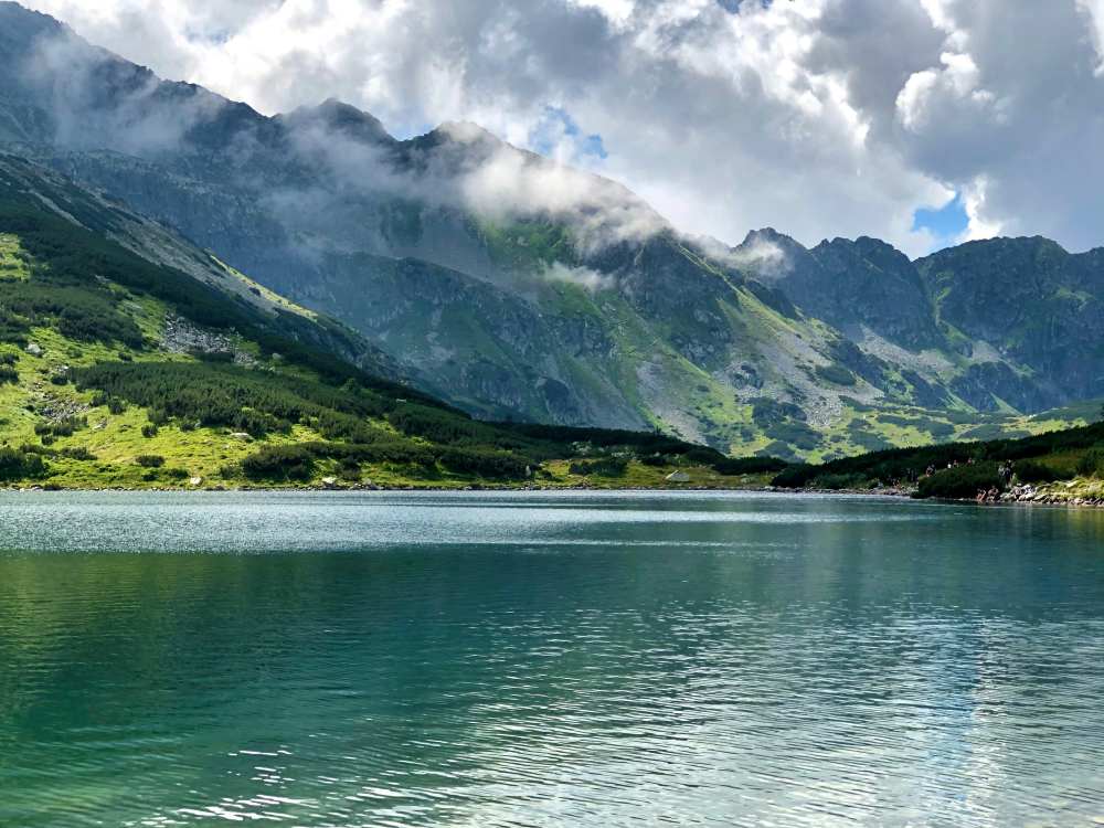 body of water with mountain at the back