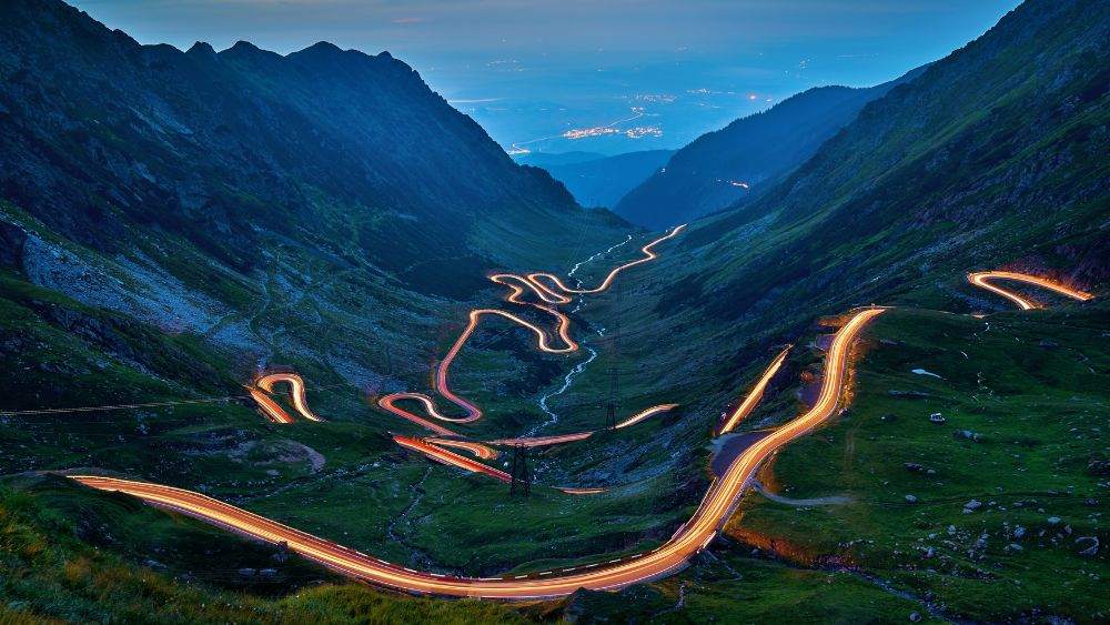curvy road in the iddle of the mountains- Best road trips in Europe